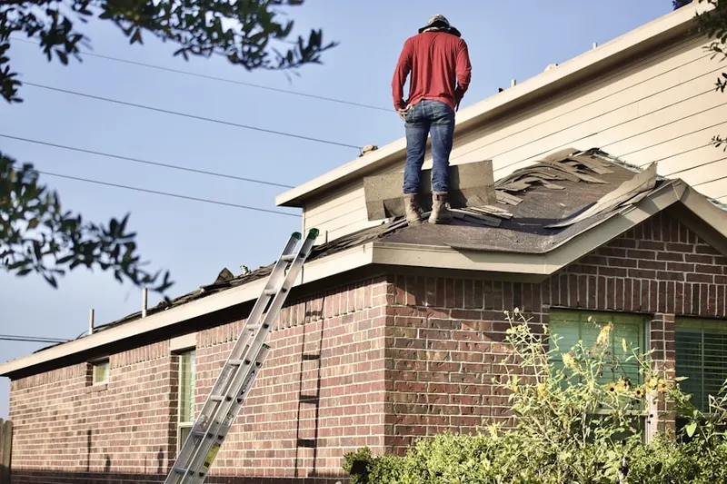 Professional roofer working on a residential roof in Farm School
